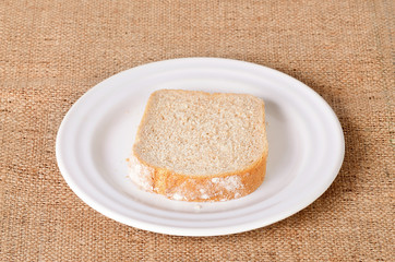 Sliced bread on sackcloth background