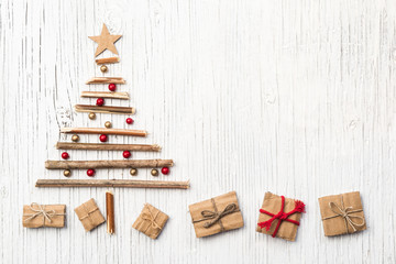 Christmas tree made of wooden branches and gift box