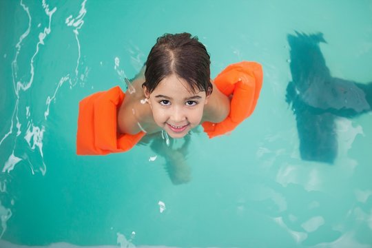 Little boy smiling in the pool