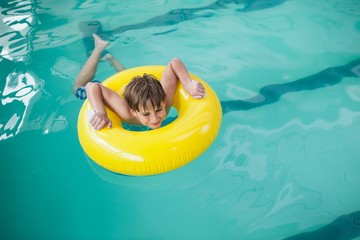 Little boy swimming with rubber ring