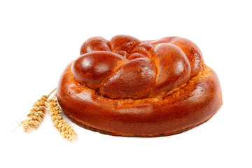 Bread loaf and wheat ear on a white background.