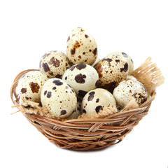 Naklejka na ściany i meble Quail eggs in a basket on white background.