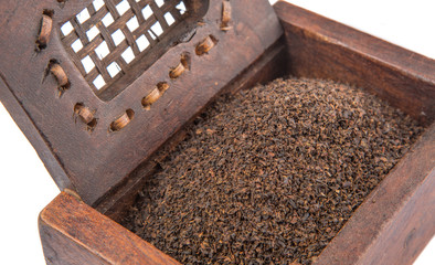 Dried, processed and blended tea leaves in wooden box