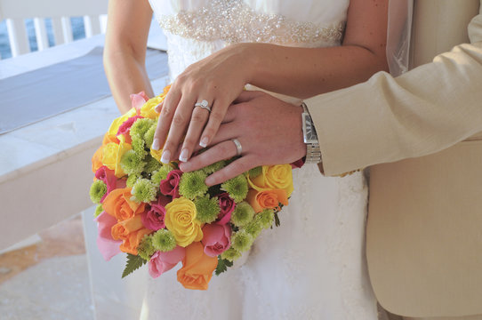 Bride and groom hands and flowers
