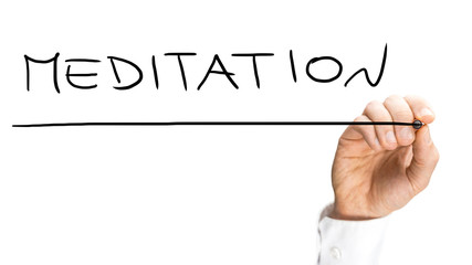 Businessman writing Meditation with a black marker