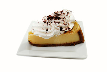 Served Cheesecake with Whipped Cream and Crumbled Chocolate