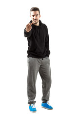 Young man in hoodie with middle finger gesture