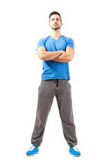 Serious fit guy with crossed hands and head back
