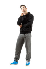 Naklejka premium Young man in hoodie thinking looking up