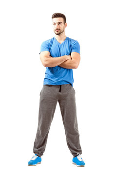 Confident fit male with folded hands looking away