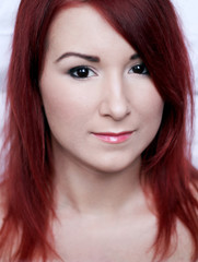 Naklejka premium Beautiful smiling redhead young woman with bright make up portra