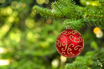 Christmas ball hanging on abstract lights background