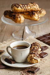 Cup of coffee and eclairs