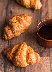 croissant with chocolate on a wooden board, breakfast