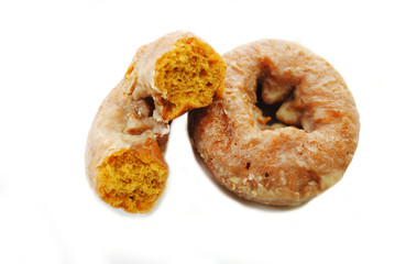 Half of a Pumpkin Donut Leaning on a Whole Donut