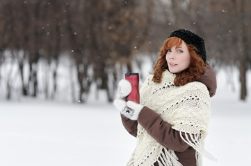 Young beautiful woman in winter park