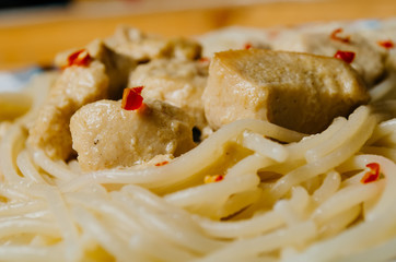 Pasta with meat with slices of red pepper
