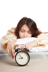Sleeping Asian girl with alarm clock