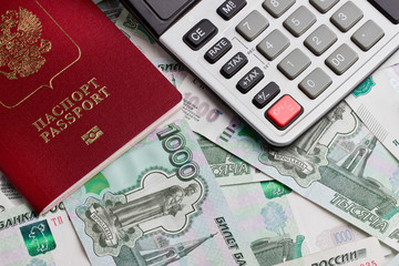 Passport and the calculator on a background of money