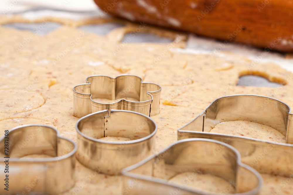 Wall mural Cookie cutters on fresh dough