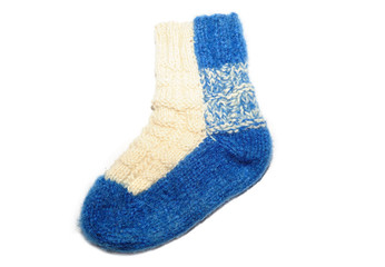 Warm knitted woolen sock knitting needles isolated on a white ba