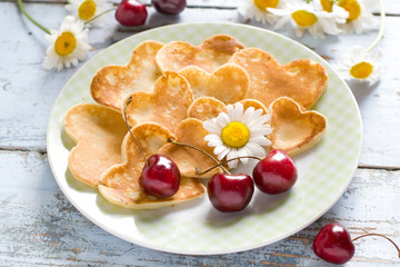 Heart shaped pancakes with cherry