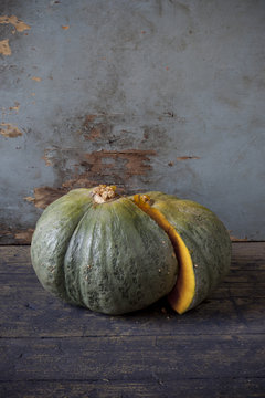 pumpkin cut in half on wooden table and scraped background