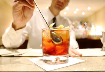 barman mixing a cocktail © TTLmedia