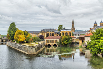 Buildings reflecting in water in the center of Metz