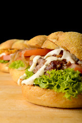 Appetizing veggie, fish and beef burgers with toppings