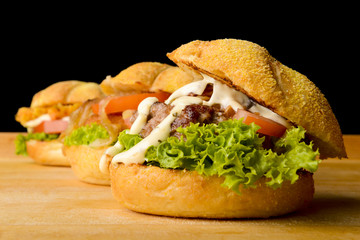 Appetizing veggie, fish and beef burgers with toppings
