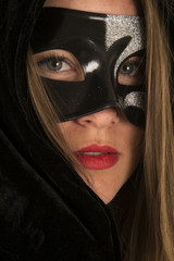 woman mask cloak lipstick close serious face