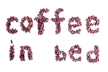 coffee beans laid out in the form of words coffee in bed isolate