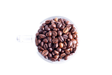 coffee beans in a glass dish on a top view of the isolated white