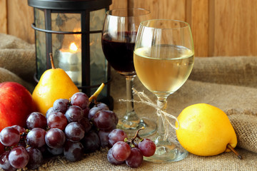 Two glasses with wine and fruit.