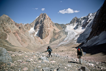 Fototapeta premium beautiful mountain landscape with two hikers in Fann mountains,