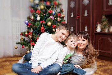 Happy mother and two her sons. Christmas photo