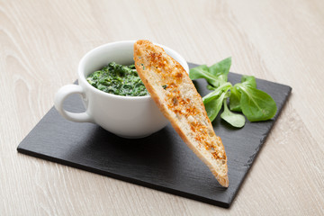 Sauteed garlic spinach dish, baked bread slice  with  melted che