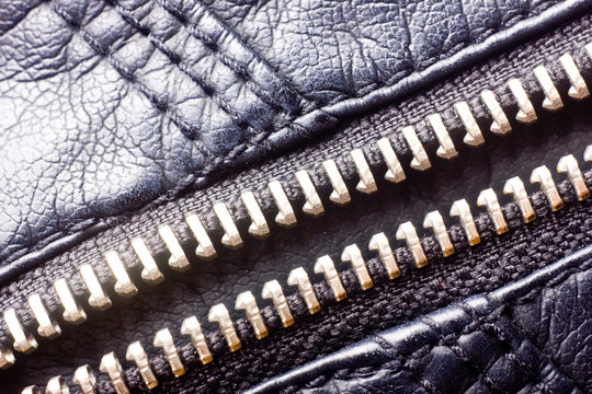 Metal zipper in leather jacket texture. 