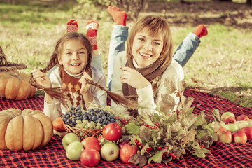 Fototapeta na wymiar Happy mother with little daughter in autumn park
