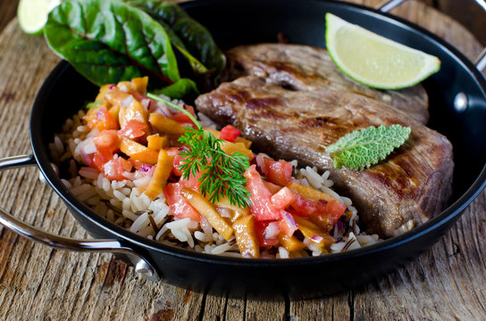 Baked meat with rice and tomato-peach salsa