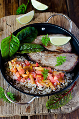 Baked meat with rice and tomato-peach salsa