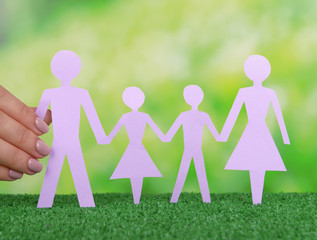 Woman hands holding paper family close up