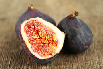 Ripe sweet figs on wooden background