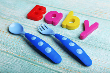 Baby word formed with colorful letters on wooden background