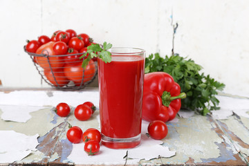Glass of tomato juice and fresh vegetables