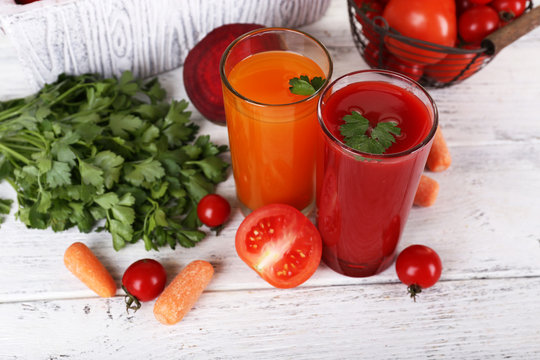Vegetable juice and fresh vegetables  on wooden background