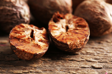 Nutmegs on wooden background