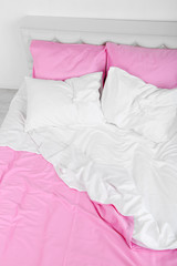 Crumpled pink linen on bed