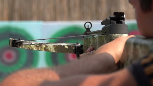 man shoots a crossbow at a target, Slow Motion 1